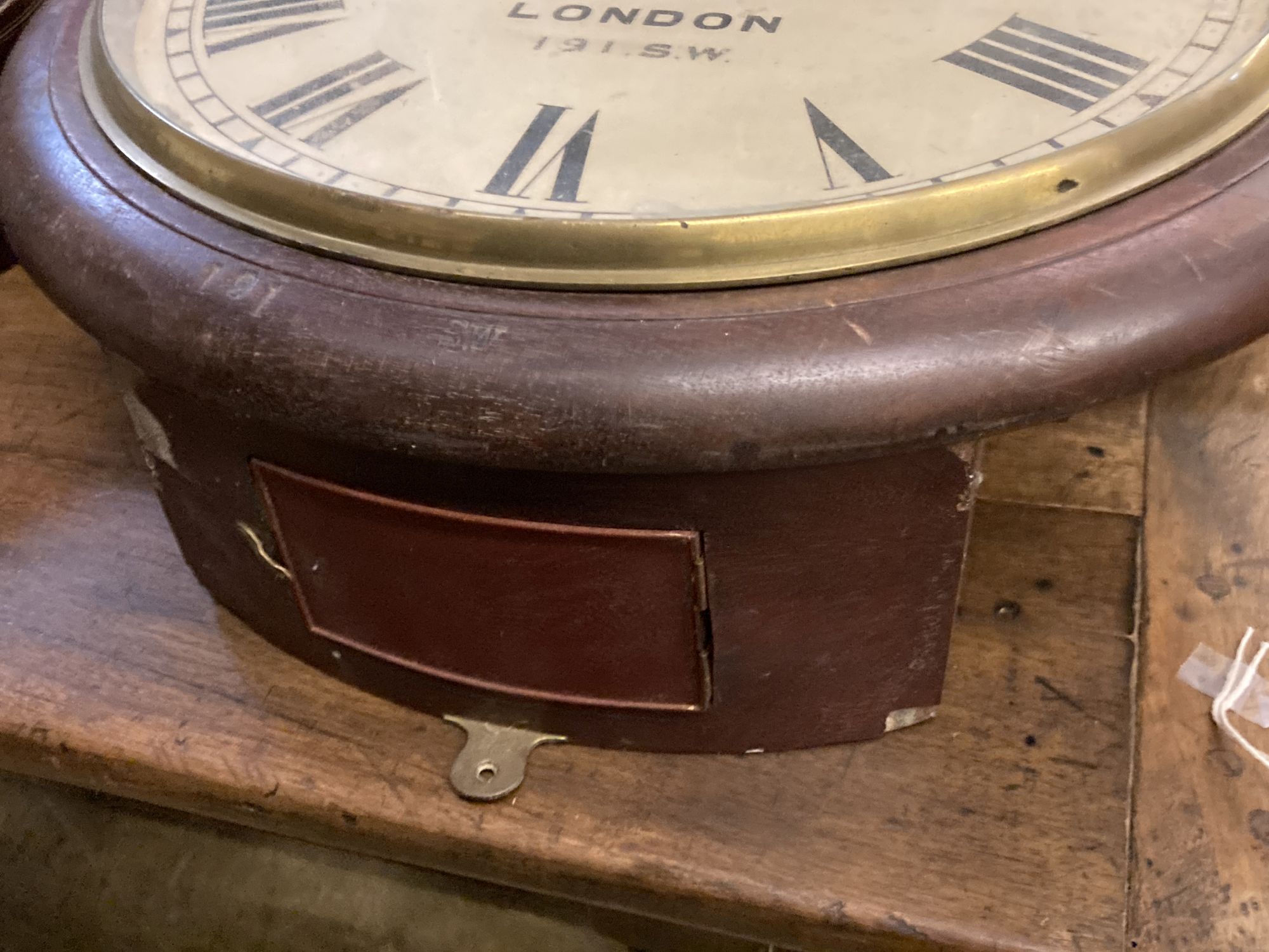 A large British Rail mahogany wall clock case, lacking movement, stamped 191SW, Diameter 57cm.